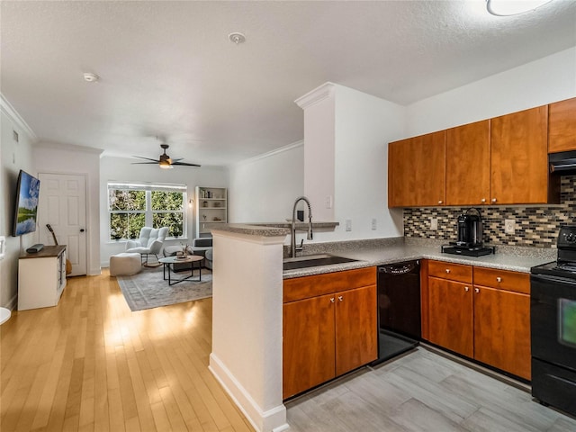 kitchen with sink, black appliances, light hardwood / wood-style flooring, and crown molding