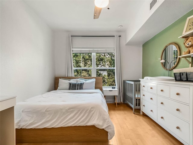 bedroom with ceiling fan and light hardwood / wood-style flooring