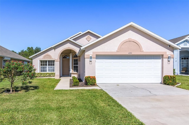 ranch-style house featuring a front lawn and a garage