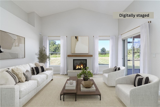 carpeted living room with high vaulted ceiling