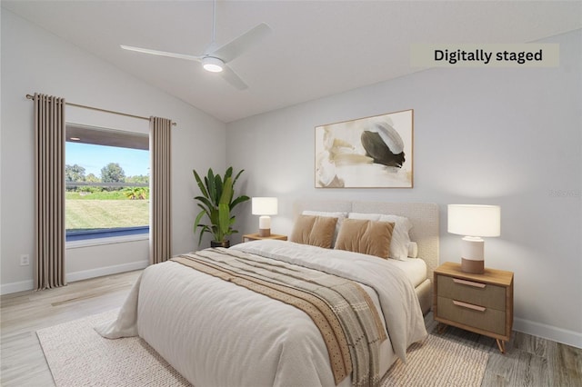 bedroom featuring lofted ceiling, light hardwood / wood-style floors, and ceiling fan