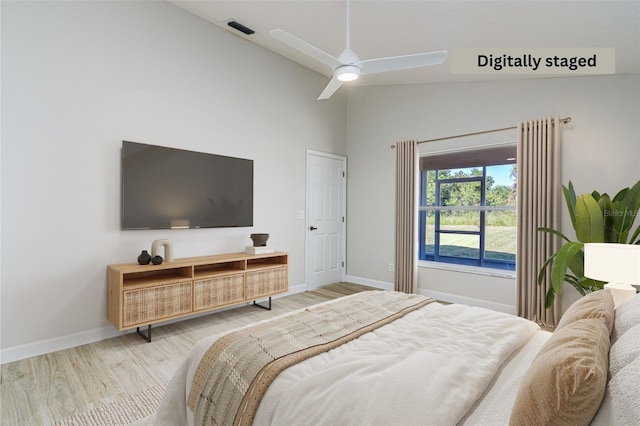 bedroom featuring hardwood / wood-style floors, vaulted ceiling, and ceiling fan