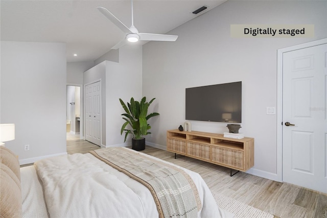 bedroom with ceiling fan, lofted ceiling, and light hardwood / wood-style flooring