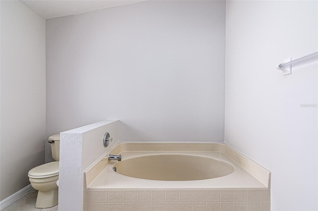 bathroom with a relaxing tiled tub and toilet