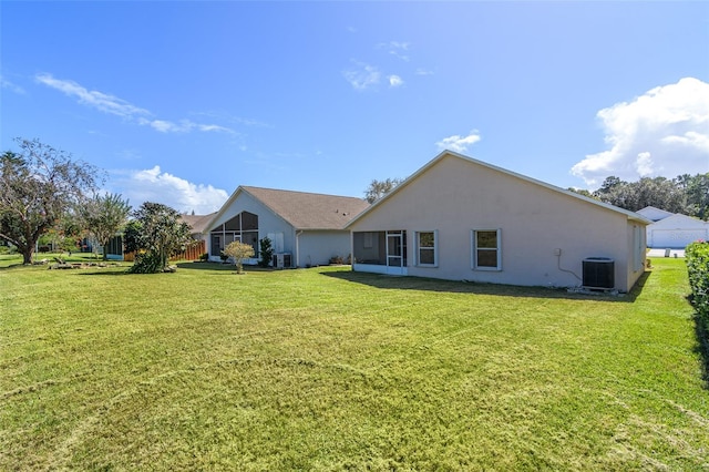 back of house with a yard and cooling unit