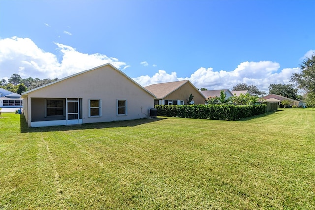 exterior space with a yard and central AC