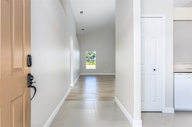 hall featuring lofted ceiling and light wood-type flooring