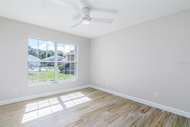 spare room featuring light hardwood / wood-style flooring and ceiling fan