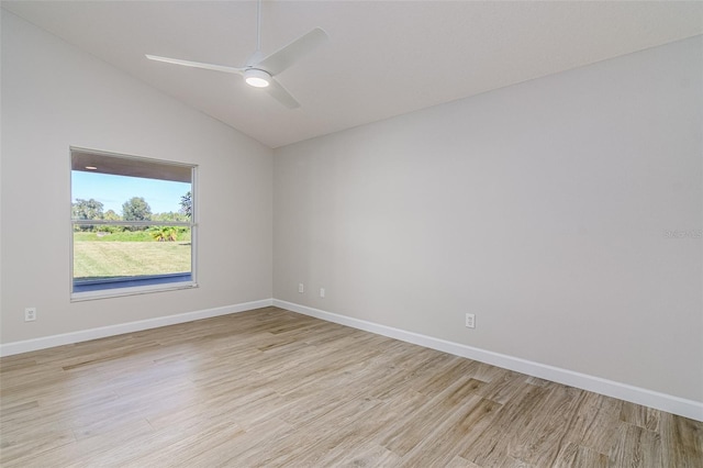 empty room featuring vaulted ceiling, light hardwood / wood-style floors, and ceiling fan