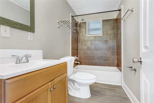 full bathroom with vanity, toilet, hardwood / wood-style floors, and tiled shower / bath