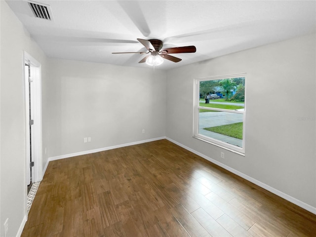 spare room featuring ceiling fan and dark hardwood / wood-style flooring