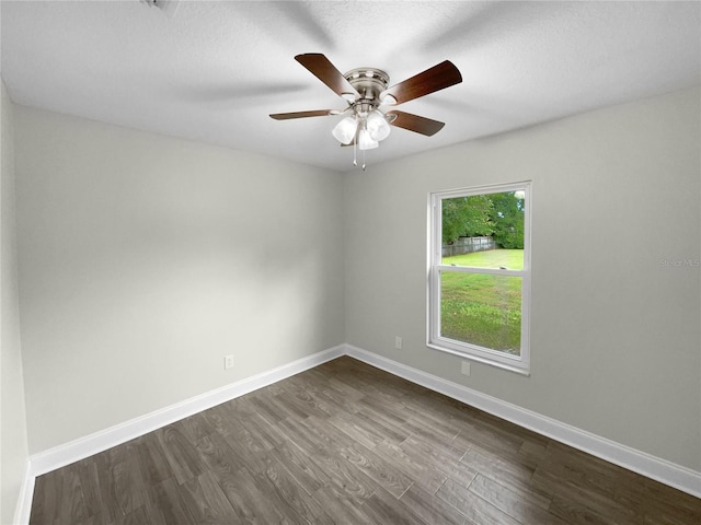 empty room with dark wood-type flooring, a textured ceiling, and ceiling fan