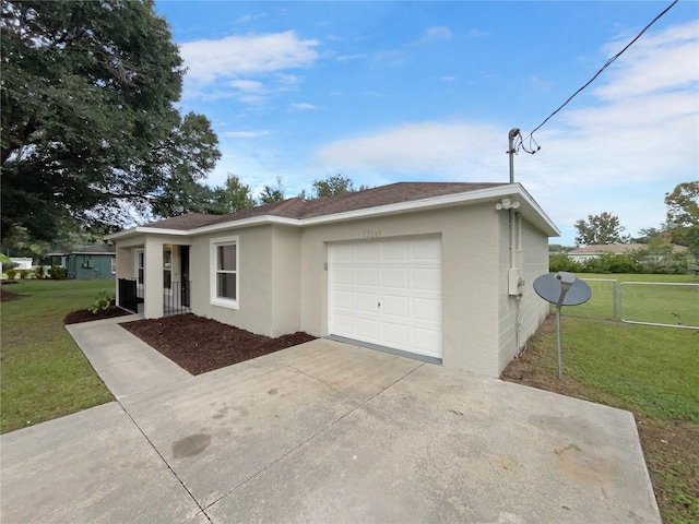 single story home featuring a front lawn and a garage