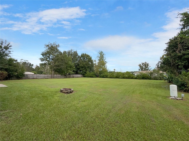 view of yard with an outdoor fire pit