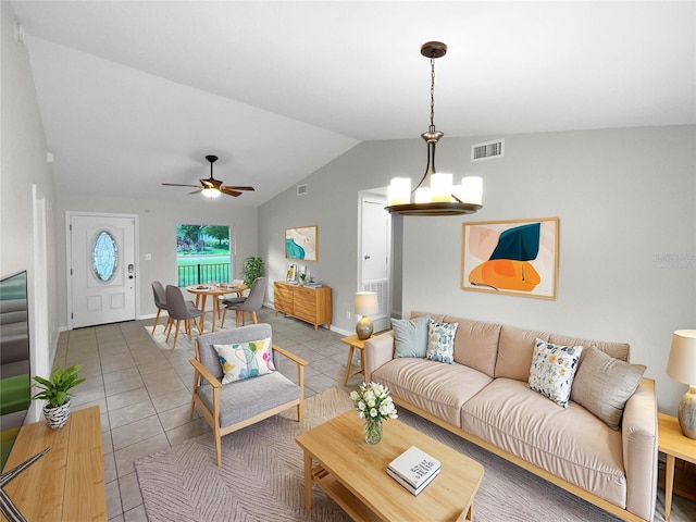 living room with vaulted ceiling, tile patterned flooring, and ceiling fan with notable chandelier