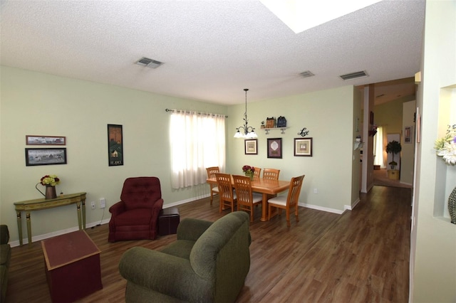 living room featuring a chandelier, a textured ceiling, and dark hardwood / wood-style flooring