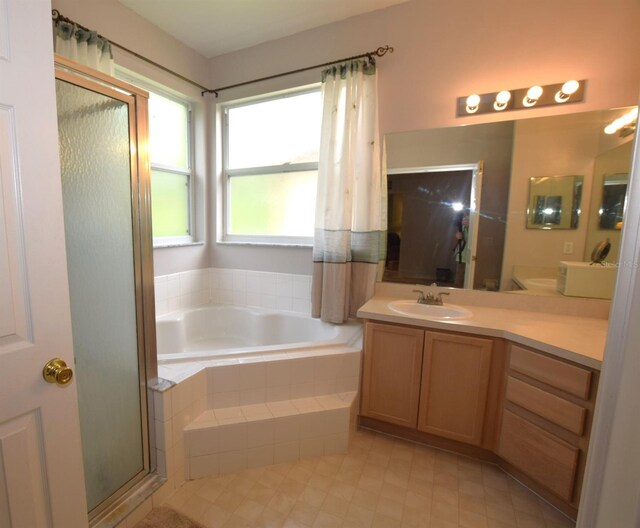 bathroom with vanity and plus walk in shower