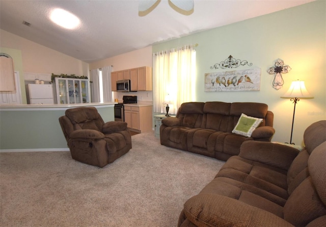 living room featuring vaulted ceiling and light colored carpet