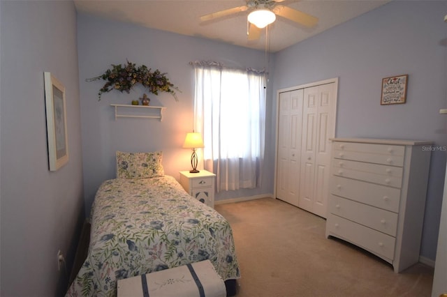 carpeted bedroom with a closet and ceiling fan