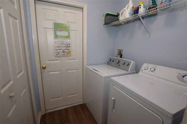 laundry area with dark hardwood / wood-style floors and washing machine and clothes dryer