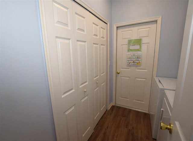 doorway with dark wood-type flooring and washer and dryer