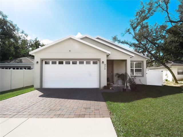 single story home with a garage and a front lawn