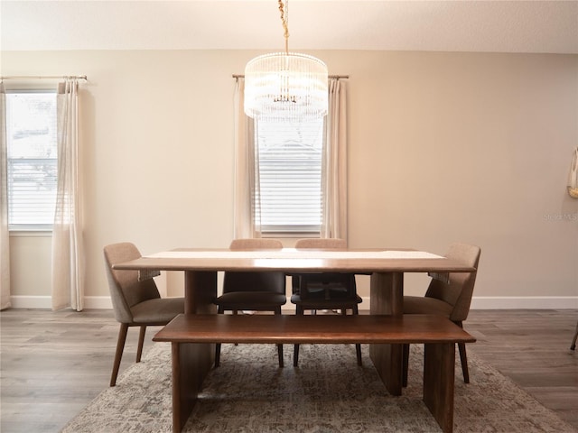 dining area featuring a chandelier and hardwood / wood-style flooring