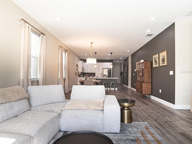 living room with dark hardwood / wood-style flooring