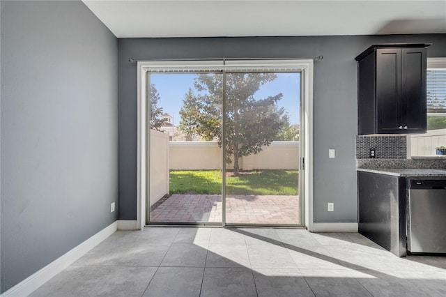 doorway to outside with light tile patterned flooring