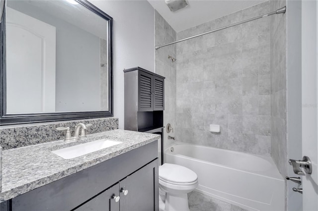 full bathroom with vanity, toilet, and tiled shower / bath