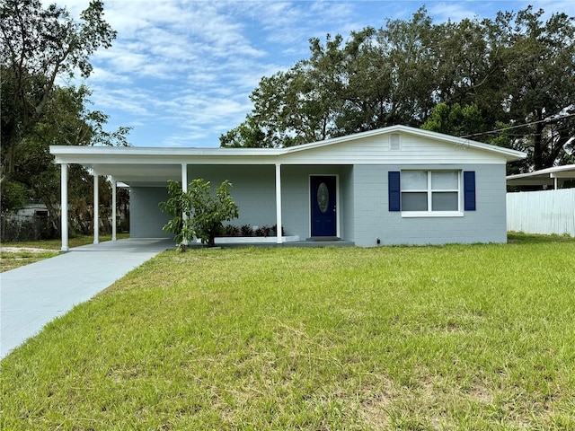 single story home featuring a front lawn and a carport