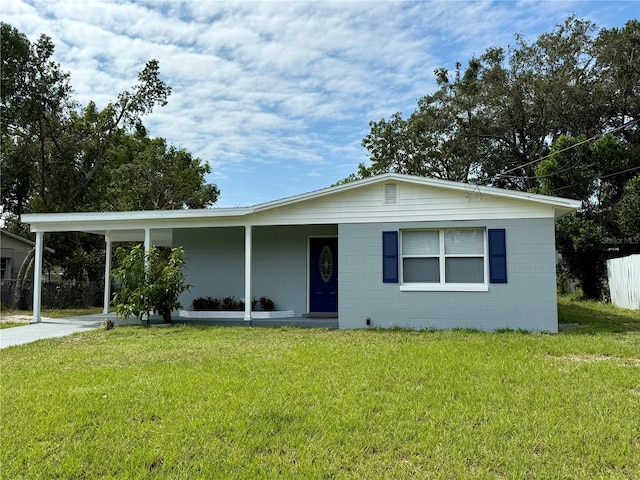 ranch-style house featuring a front yard and a carport