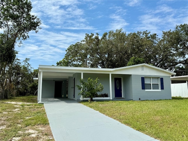 ranch-style home with a front lawn and a carport