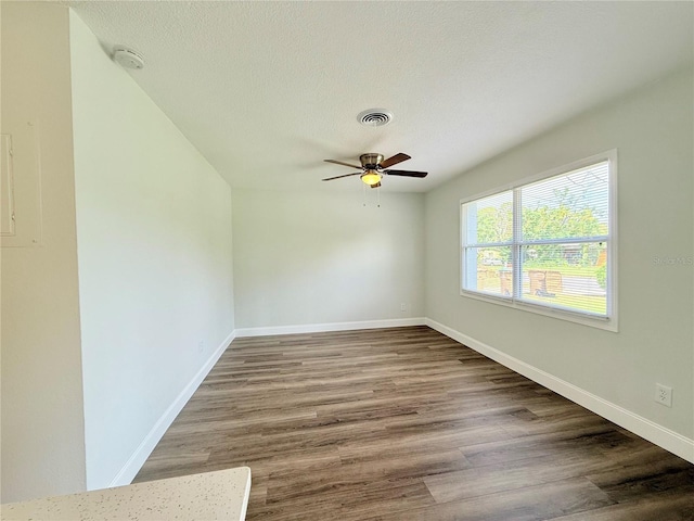 spare room with ceiling fan, a textured ceiling, and hardwood / wood-style floors