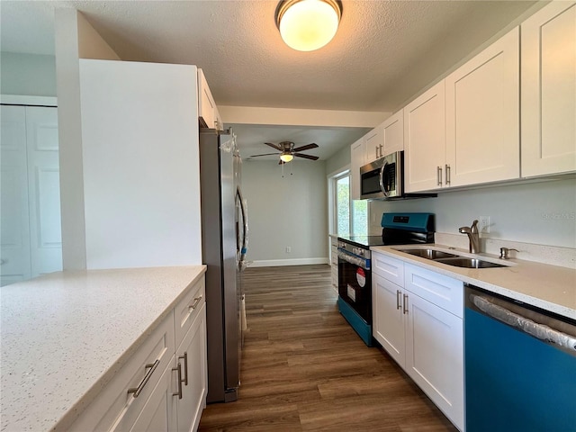 kitchen with appliances with stainless steel finishes, white cabinets, and sink