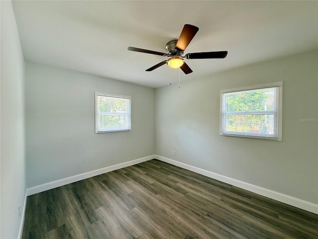 unfurnished room with dark hardwood / wood-style floors and ceiling fan