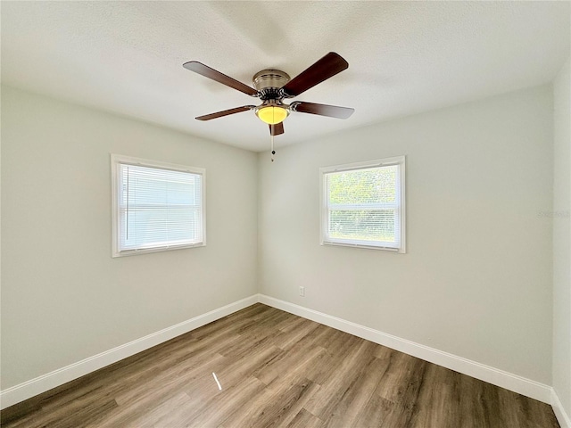 unfurnished room with a textured ceiling, light hardwood / wood-style floors, and ceiling fan