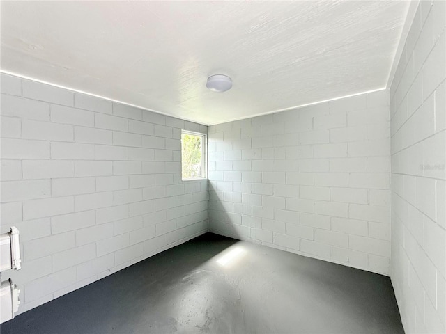 unfurnished room with concrete floors