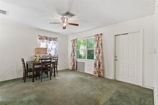 carpeted dining space featuring ceiling fan