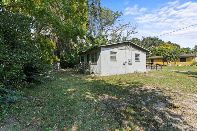 view of property exterior with a lawn