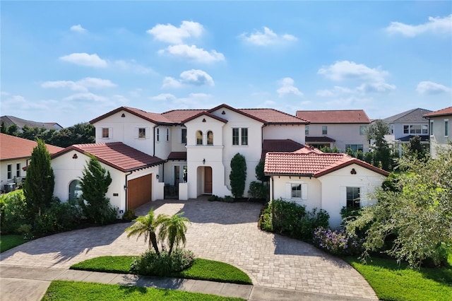 mediterranean / spanish house with a garage