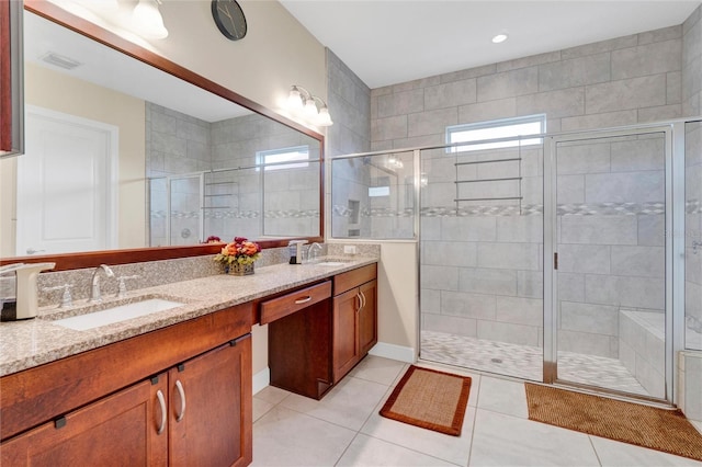 bathroom featuring vanity, tile patterned flooring, and a shower with door