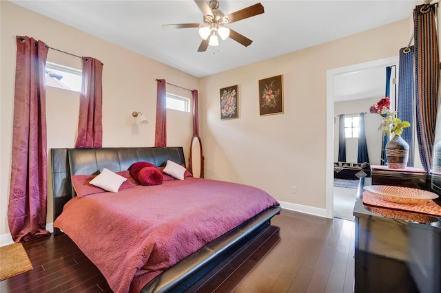 bedroom with multiple windows, ceiling fan, and dark hardwood / wood-style floors