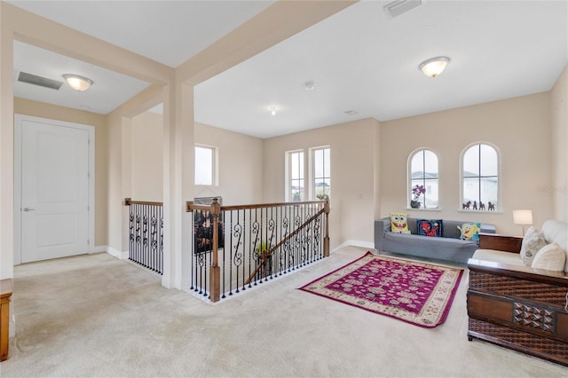 interior space featuring light carpet and plenty of natural light