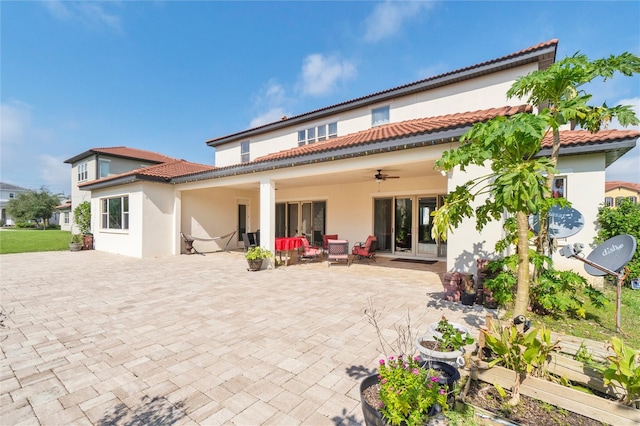 back of property featuring ceiling fan, an outdoor living space, french doors, and a patio