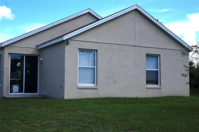 view of side of property featuring a yard