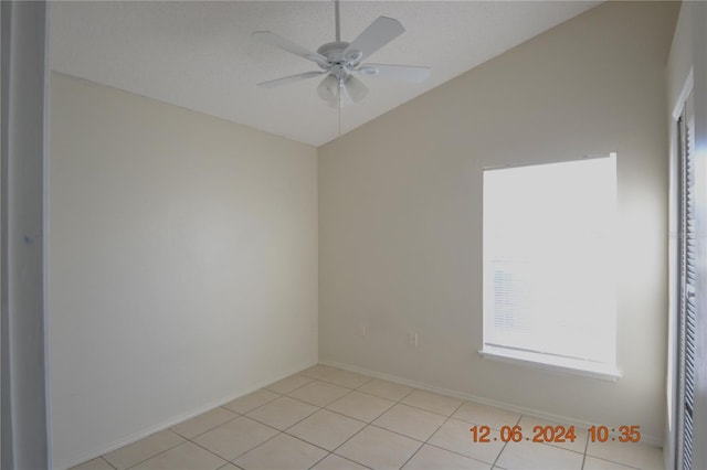 tiled empty room with a wealth of natural light and ceiling fan