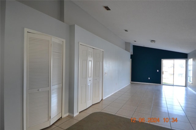 interior space featuring a textured ceiling and lofted ceiling