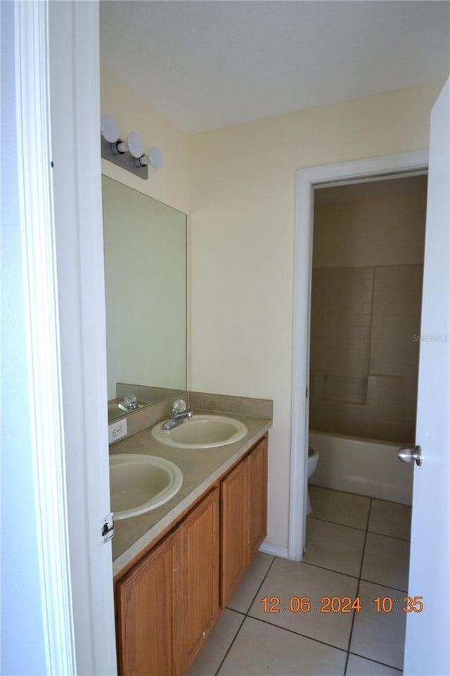 bathroom featuring tile patterned flooring, vanity, and toilet