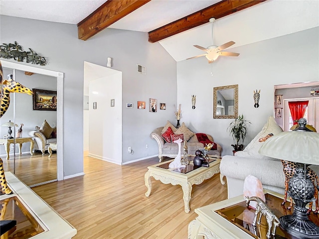 living room featuring ceiling fan, vaulted ceiling with beams, and hardwood / wood-style floors